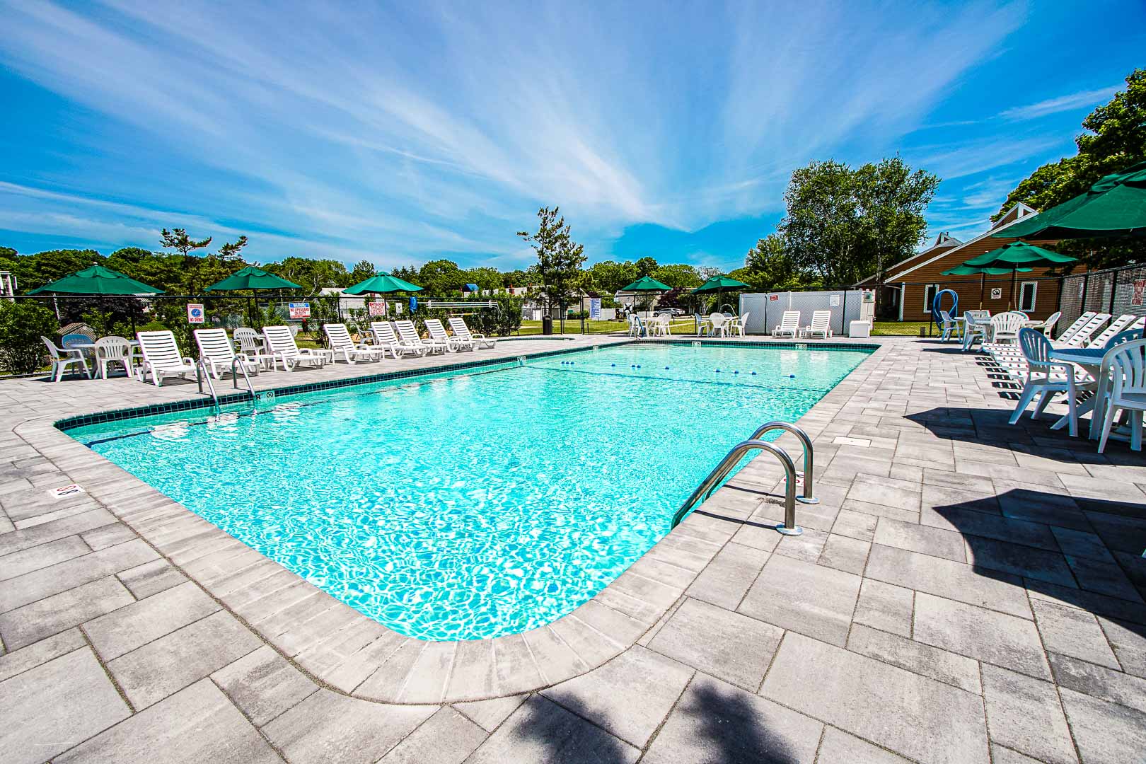 A expansive view of the outdoor swimming pool at VRI's Brewster Green Resort in Massachusetts.